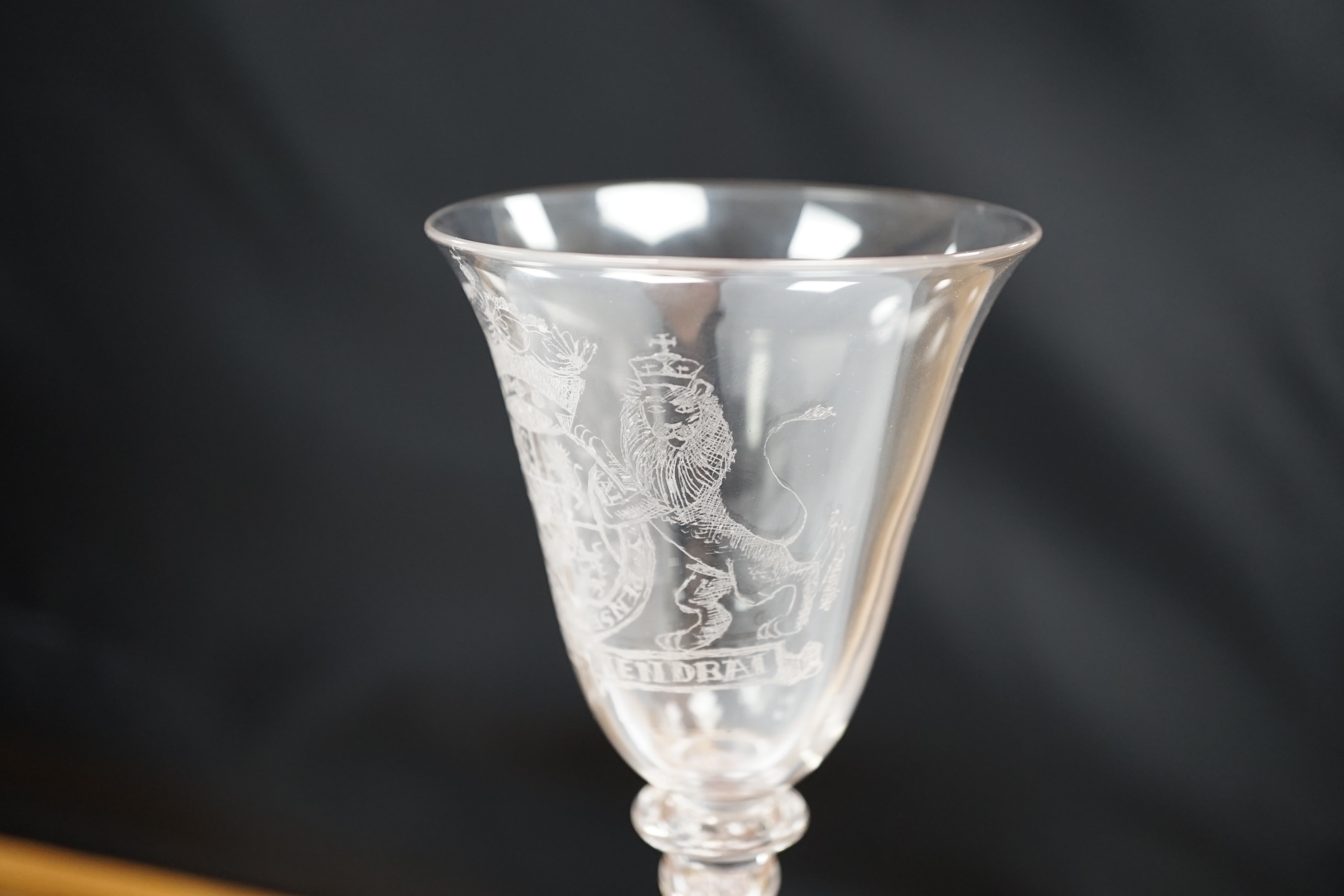 An 19th century diamond point engraved armorial glass, with knopped stem, air tears and rough pontil, 18cm